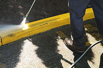 Pressure washing commercial parking lot surface